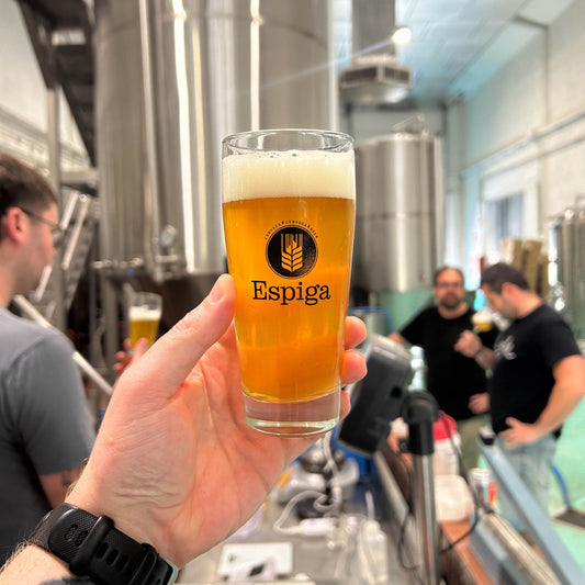 A pint offull circle x espiga beer in a brewery.