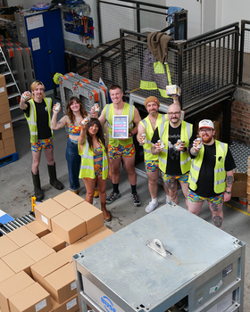 The team and Full Circle Brew Co and Kieran from The OddBalls Foundation holding the collab beer Hippy Jungle in the brewery at Full Circle Brew Co