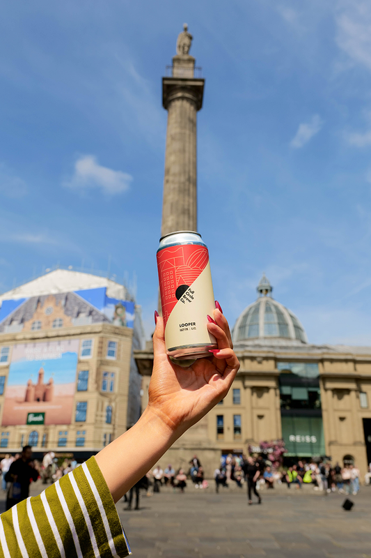 A can of Looper from Full Circle  being held up in the air in Newcastle City Centre