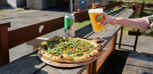 Full Circle Brew Co Newcastle upon Tyne Craft Beer in a glass vegan pizza outdoors in sunny beer garden terrace