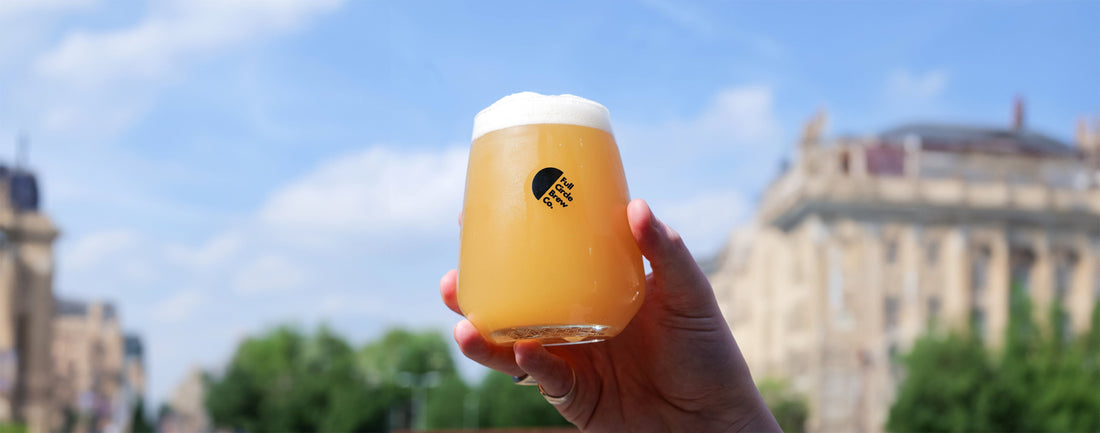 a schooner of pale refreshing beer being held up to the sun